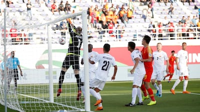 Kyrgyzstan's goalkeeper Matiash Pavel punches a cross onto his own crossbar, with the ball rebounding off him, to give China their equaliser. EPA