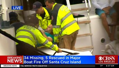 The Oxnard Fire Department assist a man who was rescued from the deadly boat fire. KCBS via AP