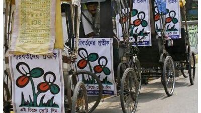 A man sits in a trishaw decorated with Trinamool Congress (TMC) placards on a roadside in Kolkata Monday. Voters streamed into polling stations in West Bengal on Monday in state elections that could see populist maverick Mamata Banerjee unseat the world's longest-serving, democratically-elected communist government and emerge as a key power broker. The placards read: "Symbol of change, vote for Trinamool Congress".