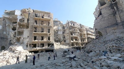 Syrians stand amidst the destruction in the eastern Shaar neighbourhood of the northern Syrian city of Aleppo. Zein Al Rifai / AFP