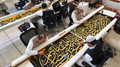 Workers embroider Islamic calligraphy, using either pure silver thread or gold-plated silver thread, during the final stages in the preparation of a drape, or kiswa, that covers the Kaaba. AP