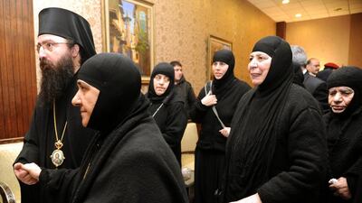 A group of nuns who were freed after being held by rebels greet church officials at the Syrian border town of Jdeidat Yabous on March. 10. AP/SANA