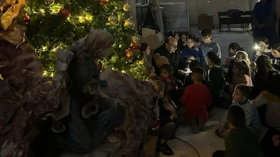 Children learn the message of hope and courage near a Christmas tree at the Holy Family Church in Gaza. Photo: Holy Family Church Gaza