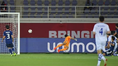 Japan's Daniel Schmidt, centre, dives to catch the ball. AFP
