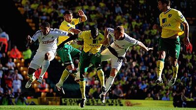 Russell Martin, right, scores with a header as Norwich dominated their Premier League match against Swansea. Jamie McDonald / Getty Images