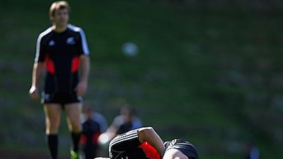 Dan Carter goes down injured at kicking practice yesterday. His injured groin forces the All Blacks fly-half out of the Rugby World Cup.