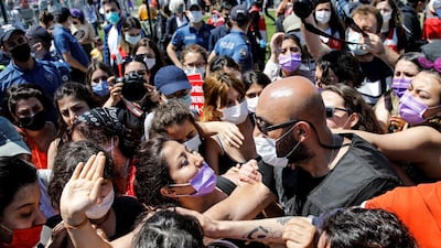 A plain-clothes police officer scuffles with a protester at a march in Istanbul against Turkey's abandonment of the Istanbul Convention. Reuters