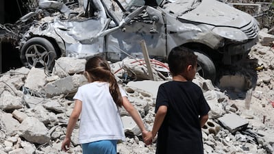 Children walk around the rubble of Maaroub village in southern Lebanon following an Israeli air attack that took place after the announcement of a US-Iran framework to end the regional war. EPA