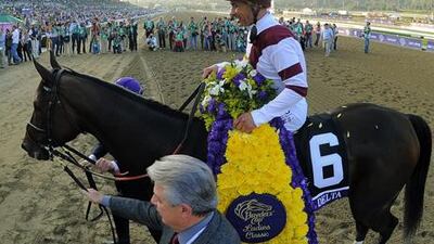 Mike Smith celebrates on Royal Delta after victory in the Breeders' Cup Ladies' Classic