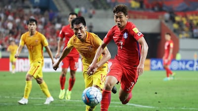 Son Heung-min of South Korea and Zheng Zhi of China compete for the ball during the 2018 World Cup Group A qualifier at Seoul World Cup Stadium on September 1, 2016 in Seoul, South Korea. Chung Sung-jun / Getty Images