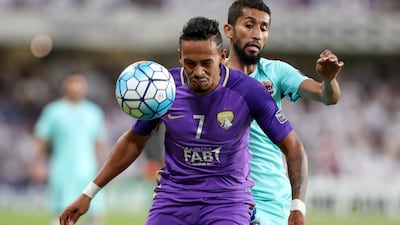 Al Ain winger Caio, front, shields the ball from Al Hilal's Salman Alfaraj during the Asian Champions League first leg quarter-final in the UAE that finished 0-0. Chris Whiteoak / The National