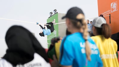 A crowd watches a participant at the rope climbing challenge on the first day of Dubai Government Games in Kite Beach, Dubai, UAE, on May 9, 2018. Reem Mohammed / The National