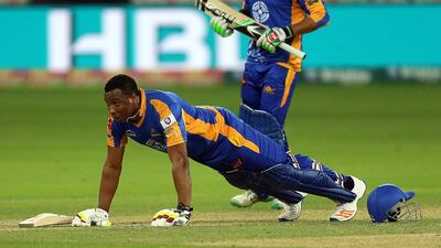 Kieron Pollard, pressing up, and Immad Wasim of Karachi Kings celebrate after winning their match against Lahore Qalanders at the Dubai International Cricket Stadium on Saturday. Satish Kumar / The National