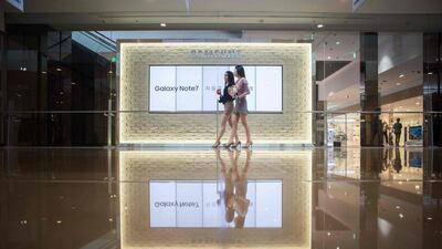 Two women walk past an advertisement for Samsung’s Galaxy Note 7 device at a Samsung store in the Gangnam district of Seoul. Samsung told customers worldwide to stop using their Galaxy Note 7 smartphones as it struggled to contain a snowballing safety crisis that threatens to derail the powerhouse global brand. AFP