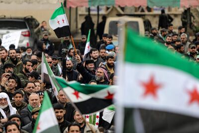 Demonstrators march in rebel-held Al Bab to mark the twelfth anniversary of the uprising. AFP