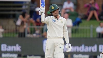 Quinton de Kock reaches celebrates reaching his half century. AP