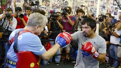 Manny Pacquiao spars with trainer Freddie Roach on Wednesday during a training session ahead of his fight against Floyd Mayweather on May 2. Michael Nelson / EPA