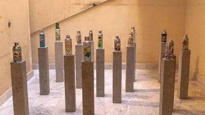'Holy Economy' (2019), with metal bottles used by pilgrims installed on cement blocks. Image courtesy Athr and the artist
