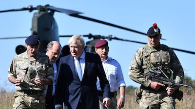 Boris Johnson arrives with Britain's Defence Secretary Ben Wallace (2L) to visit military personnel on Salisbury plain training area near Salisbury, south-west England, September 19, 2019. AFP