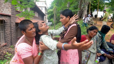 Leela Devi, centre, with arms outstretched, mourns after hearing of her husband Chiranjeevi's death in the explosion at Escientia Advanced Sciences, in Andhra Pradesh. AP