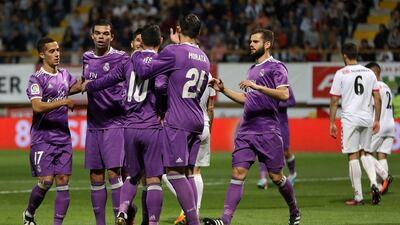 Real Madrid players celebrate their opening goal. Cesar Manso / AFP