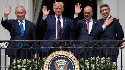TOPSHOT - (L-R)Israeli Prime Minister Benjamin Netanyahu, US President Donald Trump, Bahrain Foreign Minister Abdullatif al-Zayani, and UAE Foreign Minister Abdullah bin Zayed Al-Nahyan wave from the Truman Balcony at the White House after they participated in the signing of the Abraham Accords where the countries of Bahrain and the United Arab Emirates recognize Israel, in Washington, DC, September 15, 2020. Israeli Prime Minister Benjamin Netanyahu and the foreign ministers of Bahrain and the United Arab Emirates arrived September 15, 2020 at the White House to sign historic accords normalizing ties between the Jewish and Arab states. / AFP / SAUL LOEB