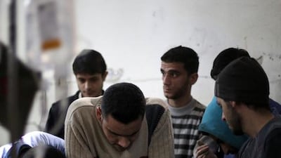 Medics try to resuscitate a man at a makeshift hospital in the rebel-held area of Douma, north-east of the capital Damascus, following reported air strikes by forces loyal to President Bashar Al Assad on February 2. Abd Doumany / AFP