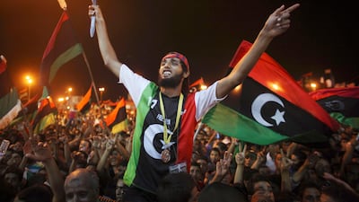 People celebrate the capture in Tripoli of Moammar Gadhafi's son and one-time heir apparent, Seif al-Islam, at the rebel-held town of Benghazi, Libya, early Monday, Aug. 22, 2011. Libyan rebels raced into Tripoli in a lightning advance Sunday that met lit???