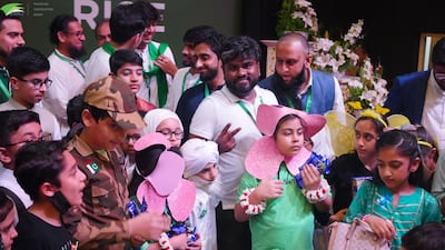 Families enjoy cake at a celebration for the Pakistan Independence Day. Photo: Pakistan Association Dubai
