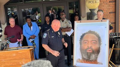 Hampton Police chief James Turner shows a picture of suspect Andre Longmore, who is now dead. AP