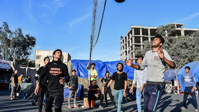 Anti-government protesters play volleyball at a protest sit-in in the southern Iraqi city of Nasiriyah in Dhi Qar province. AFP