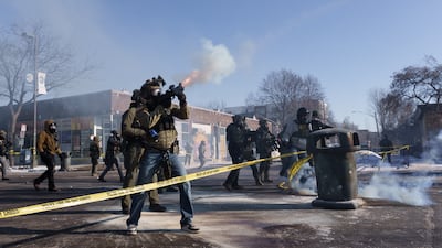 A federal agent fires a munition toward demonstrators near the site where Mr Pretti was shot. Reuters