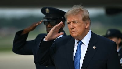 US President Donald Trump salutes after stepping off of Air Force One at Joint Base Andrews. AFP