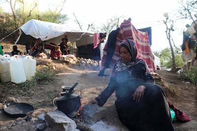 Aisha Mohammad cooks at a makeshift camp for internally displaced people in Taiz, Yemen. Reuters