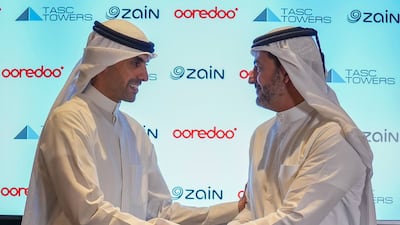 Bader Al Kharafi, vice chairman and group chief executive of Zain Group, left, and Aziz Fakhroo, managing director and group chief executive of Ooredoo, during the signing of the agreements for the Mena region's biggest telecom tower company. Photo: Ooredoo