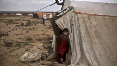 Ayshah Ibrahim, 6, and her family are preparing for the winter storm to hit the tent camp at Mafraq in Jordan. Muhammed Muheisen / AP Photo