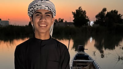 Sajjad Hassan, 16, with his wooden boat in Al Chibayish, Iraq. Photo: Azhar Al Rubaie