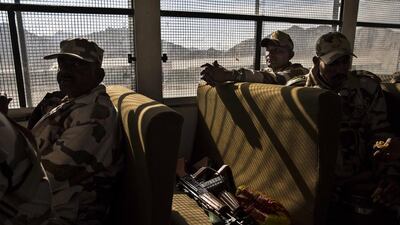 Indian security force soldiers on election duty sit in a bus as they leave a central collection point to head for a polling station.