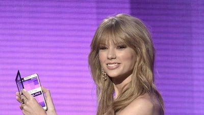 Singer Taylor Swift speaks onstage during the 2013 American Music Awards. Kevin Winter / Getty Images / AFP