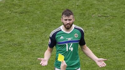 Northern Ireland’s Stuart Dallas is booked by referee Pavel Kralovec. Michael Sohn / AP Photo
