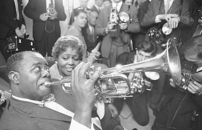 Louis Armstrong speaks to reporters at London’s Mayfair Hotel on October 12, 1960, ahead of his landmark tour of Africa. Getty Images