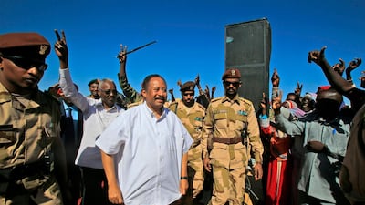 Sudan's Prime Minister Abdalla Hamdok (C) is greeted by supporters upon arriving in El-Fasher, the capital of the North Darfur state. Hamdok's one-day visit was his first as prime minister to the devastated region, where a conflict that erupted in 2003 has left hundreds of thousands dead and millions displaced. He said his government was working toward bringing peace to war-torn Darfur as he met hundreds of victims of the conflict who demanded swift justice. AFP