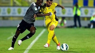 Al Dhafra’s Fawzl Bashir, left, and Al Wasl’s Saoud Saeed challenge for the ball. Christopher Pike / The National