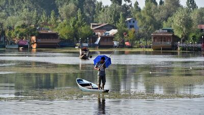 In this photo a Kashmiri man fishes on a boat in Dal Lake in Srinagar. AFP