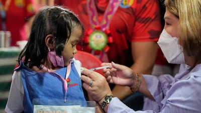 A girl receives her first Covid-19 Pfizer vaccination at San Juan Elementary School. AP Photo