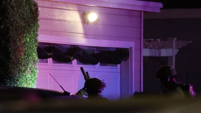 An FBI tactical team prepares to enter Mr Allen's house in Torrance, California. He had already been arrested after the shooting in which no one was killed. AFP