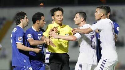 Al Ain players, right, had to be separated from Esteghlal's players by the referee. Jaime Puebla / The National