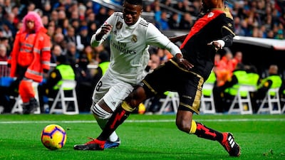 Real Madrid forward Vinicius Junior vies with Rayo Vallecano defender Abdoulaye Ba. AFP