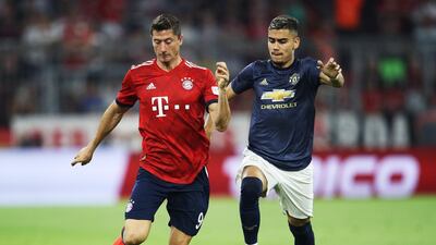 Bayern Munich's Robert Lewandowski is challenged by Manchester United's Andreas Pereira. Getty Images
