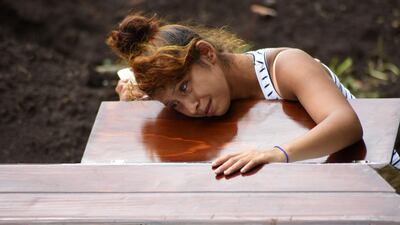A woman mourns beside the coffin of a victim of the Fuego volcano, during a funeral, on June 8, 2018. AFP / ORLANDO ESTRADA